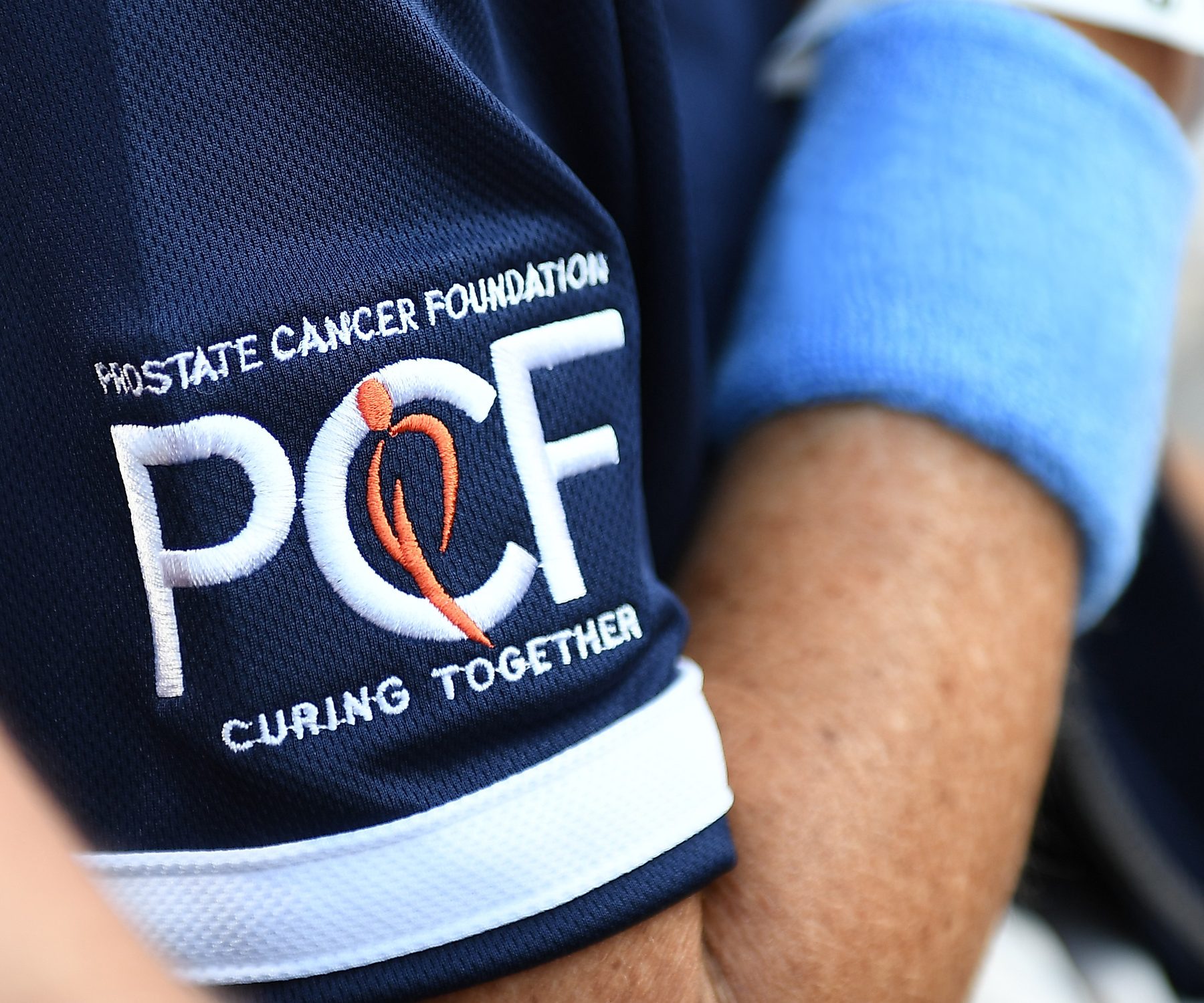 The 2024 Prostate Cancer Foundation logo, embroidered on a navy polo shirt.